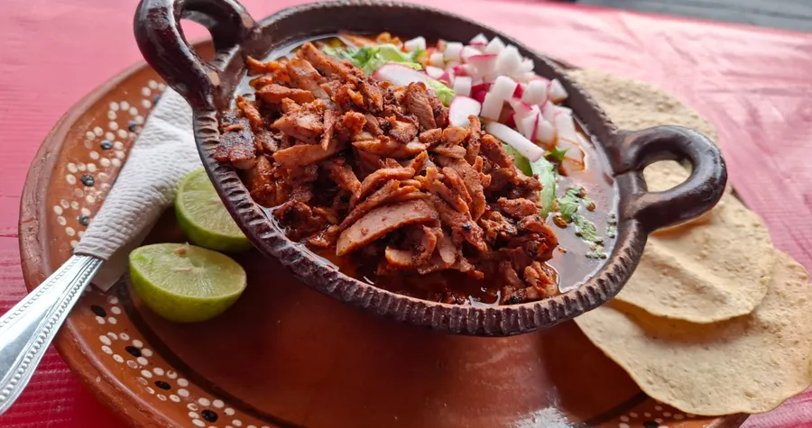 Plato de pozole con sus guarniciones